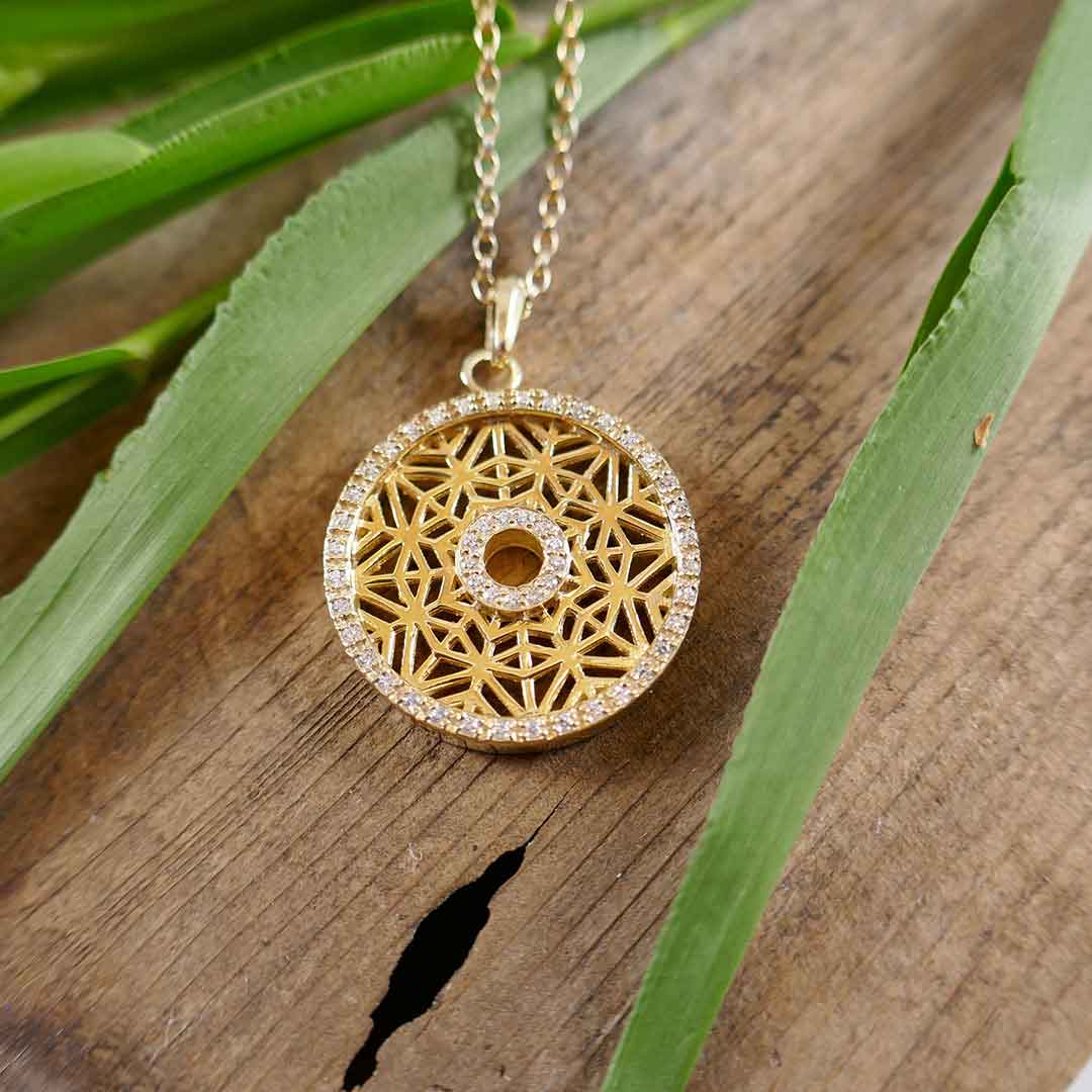 gold circular pendant on adjustable chain